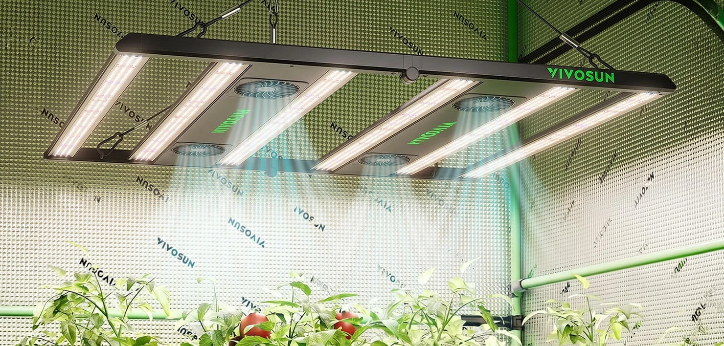 VIVOSUN VGrow LED light bar casting full-spectrum white light over young plants inside the grow box